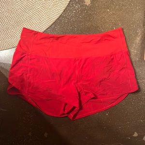 Bright red Lululemon running shorts with liner